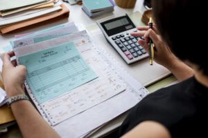 woman working through paperwork doing bookkeeping